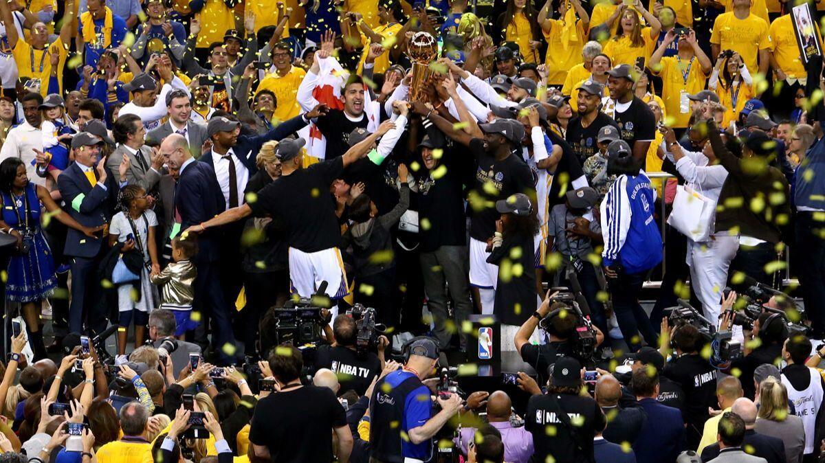 The Golden State Warriors celebrate after defeating the Cleveland Cavaliers, 129-120, in Game 5 to win the 2017 NBA Finals on June 12,