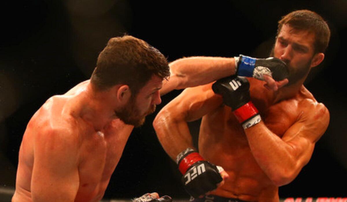 Michael Bisping connects with a left to the face of Luke Rockhold during UFC Fight Night 55 event on Nov. 8, 2014.
