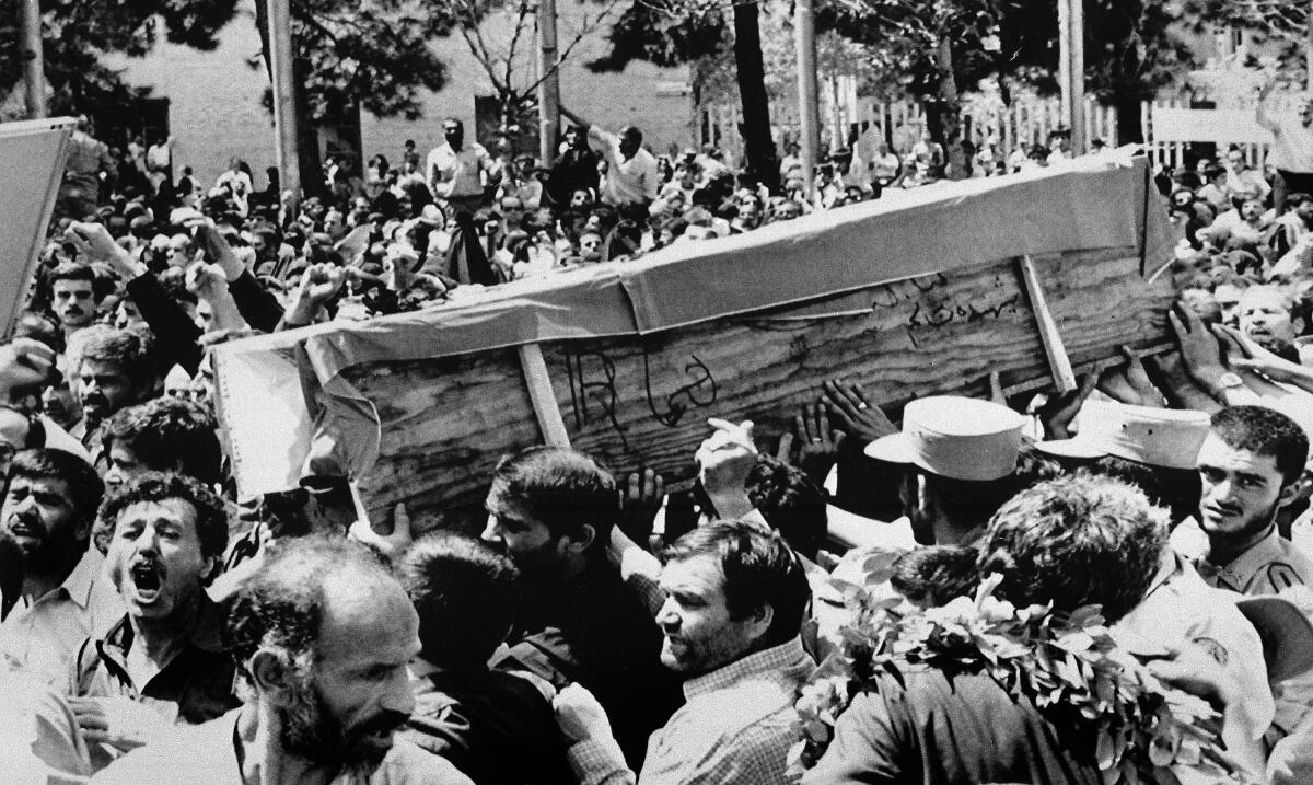 The casket of one of the people killed when the U.S. shot down an Iranian jetliner is carried through the streets of Tehran by Iranians shouting, "Death to America," on July 7, 1988.