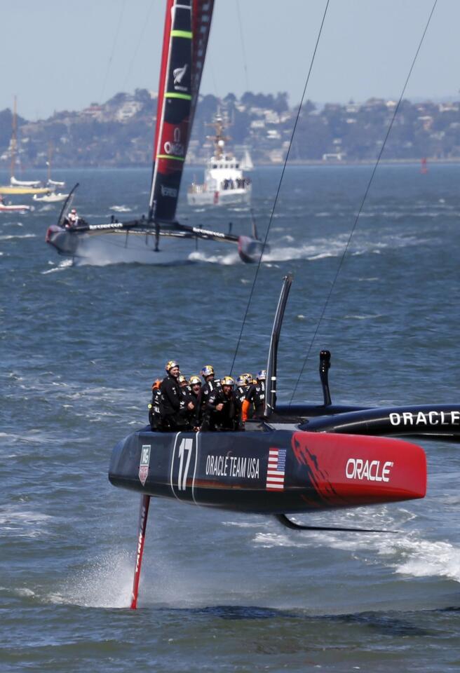 Oracle Team USA crosses the finish line to clinch victory over Emirates Team New Zealand in the America's Cup competition Wednesday on San Francisco Bay in the final, winner-take-all race.