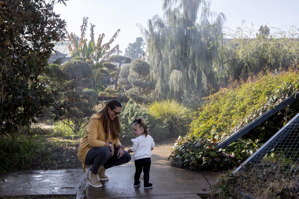 Stephanie Wilson and her daughter, Kira, 16 months, play in the children’s garden at the Huntington Library, Art Museum, and Botanical Gardens in San Marino.