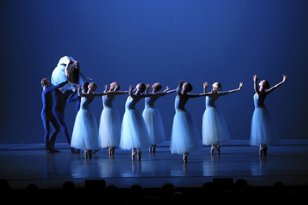 Los Angeles Ballet lead dancer Allyssa Bross is carried off stage during "Serenade."