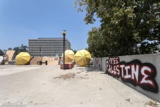 LOS ANGELES, CA - JUNE 13: Barricades remain at Greenlee Plaza blocking access to the student services building (rear) at California State University, Los Angeles in Los Angeles, CA on Thursday, June 13, 2024. The building was taken over Wednesday afternoon trapping people inside. (Myung J. Chun / Los Angeles Times)