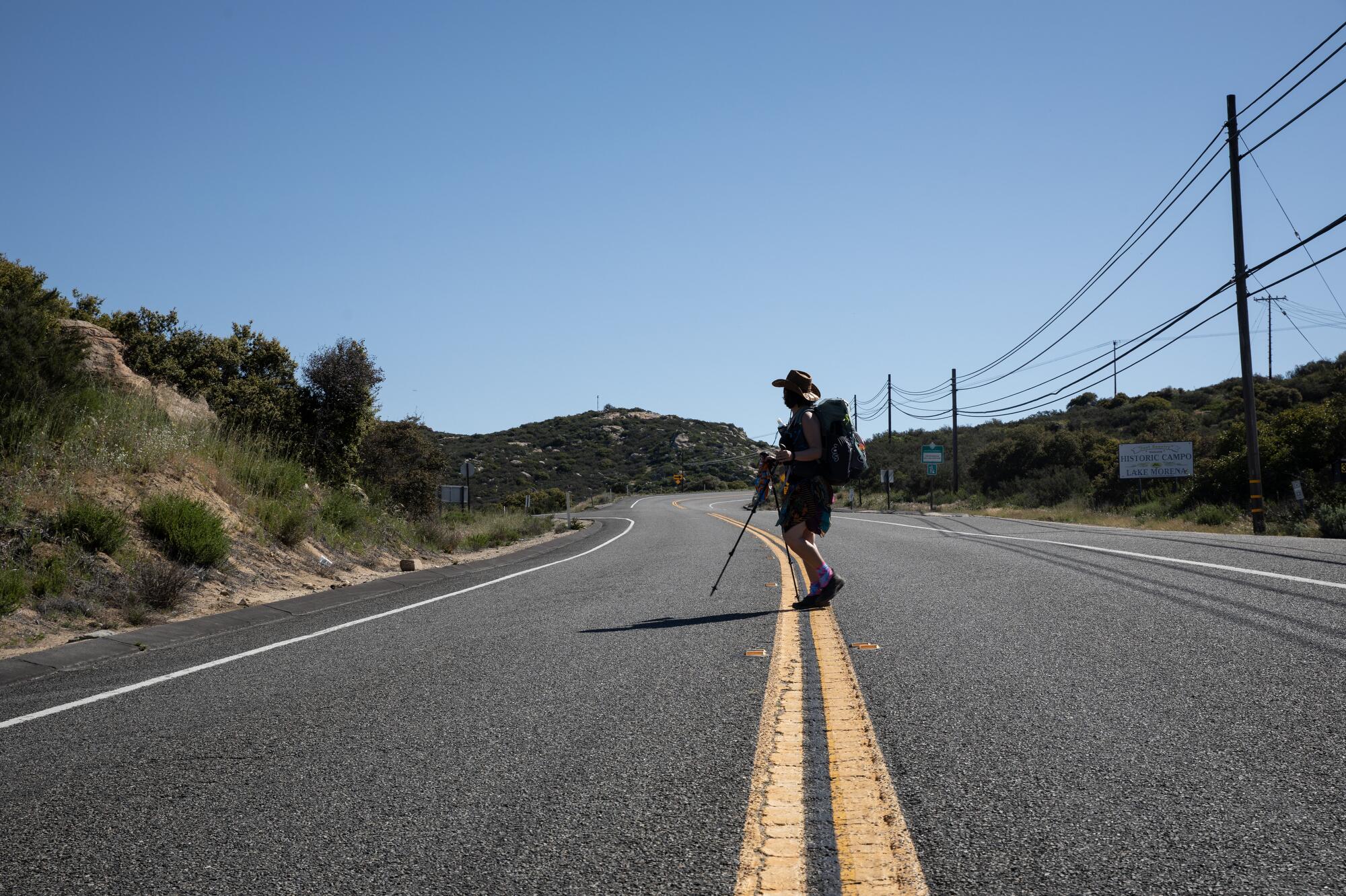 Julianne Smith, 53, of Austin, also known as Gypsy, crosses a road