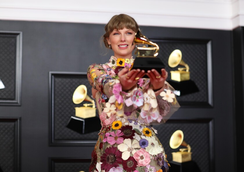 Taylor Swift in a sundress, looking back over her shoulder