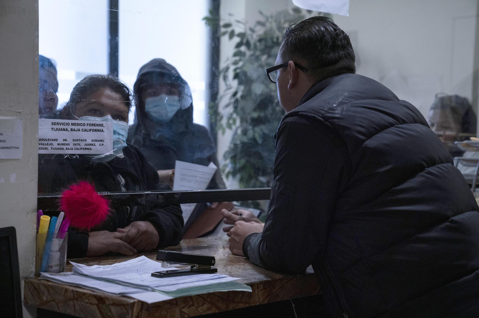 People wait in line in the morgue 