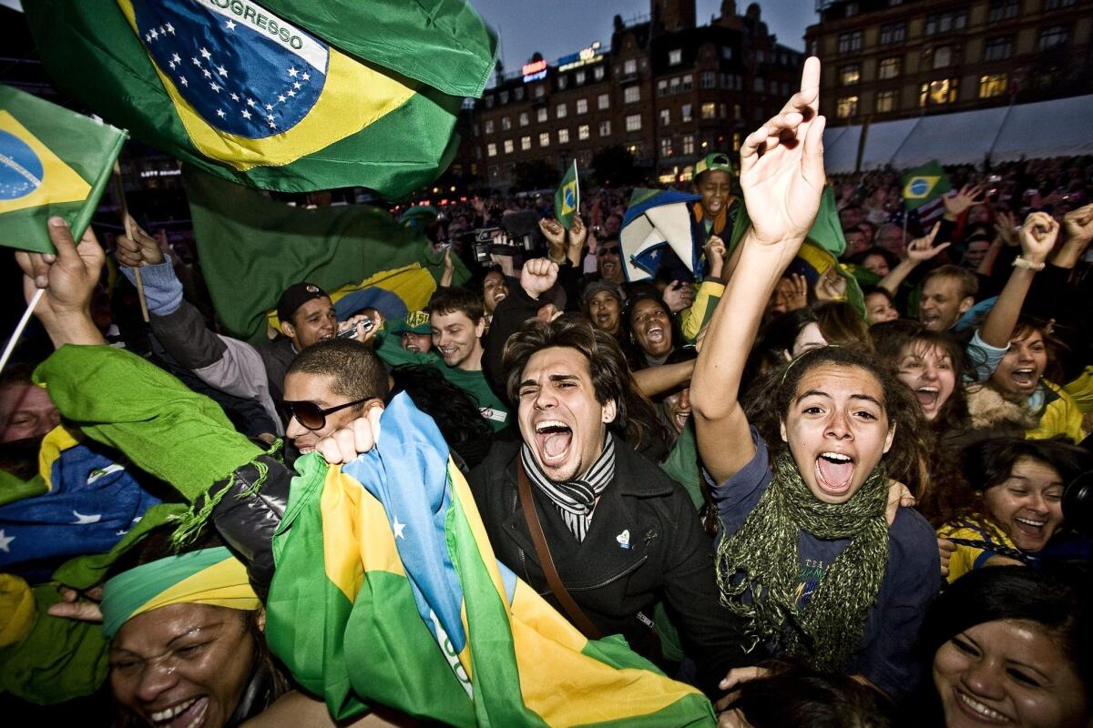 Above: Chicagoans react in 2009 after getting word from the International Olympic Committee in Copenhagen that Chicago was eliminated in its bid to host the Summer Olympics. Below: Brazilians celebrate later that same day after the IOC announced Rio de Janeiro won the 2016 Games.