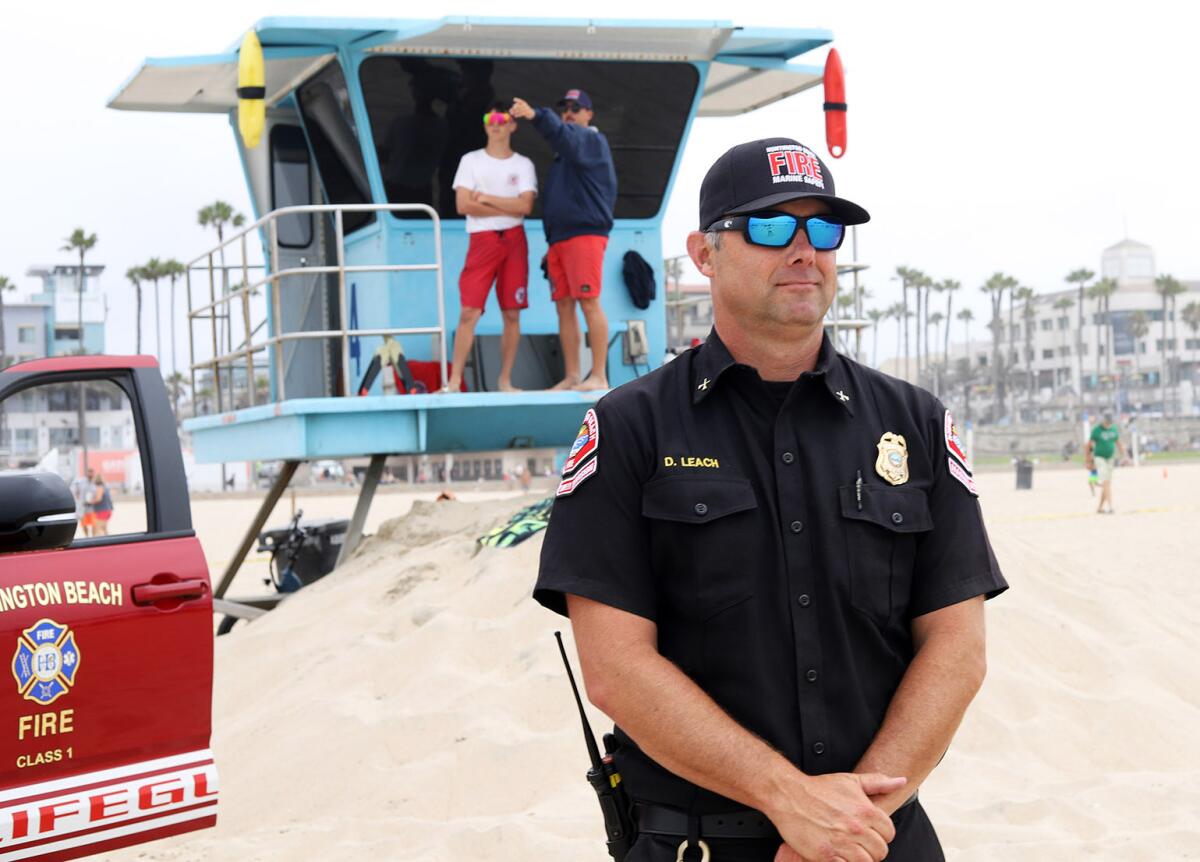 Huntington Beach Marine Safety Battalion Chief Doug Leach watches his junior lifeguards in Huntington Beach on Thursday.
