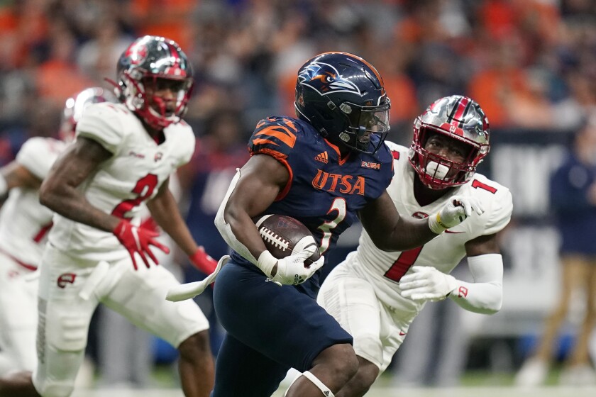 UTSA running back Sincere McCormick (3) runs around Western Kentucky defensive back Antwon Kincade (1) during the first half of an NCAA college football game in the Conference USA Championship, Friday, Dec. 3, 2021, in San Antonio. (AP Photo/Eric Gay)