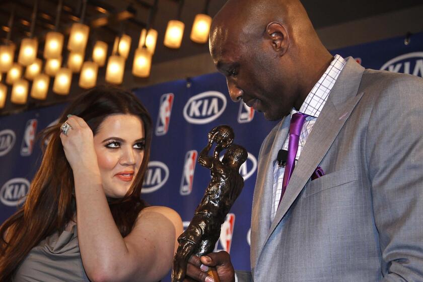 Though they signed divorce papers in July, Khloe Kardashian and Lamar Odom -- shown in 2011 after he accepted the NBA's Sixth Man award -- are still married.