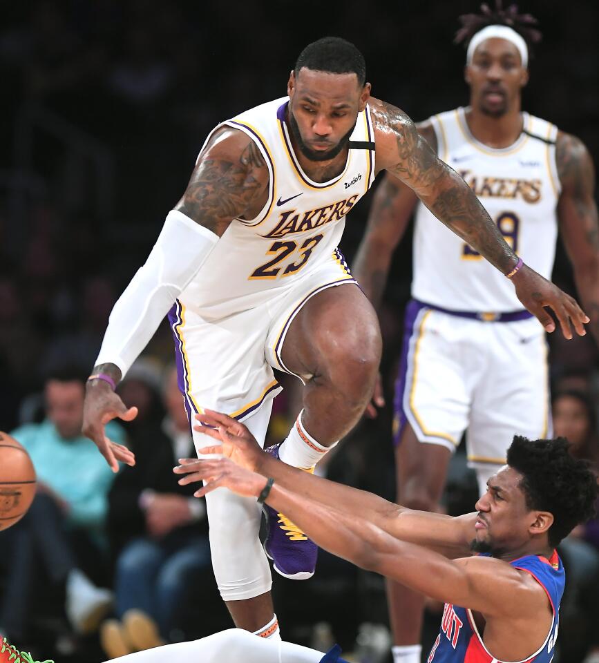 Lakers forward LeBron James tries to break up a pass by Detroit Pistons guard Langston Galloway during the second quarter.