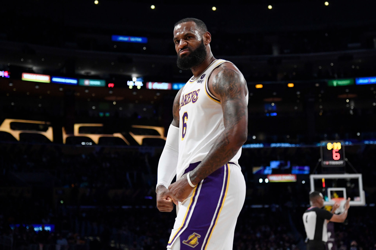 LeBron James flexes after scoring a basket.