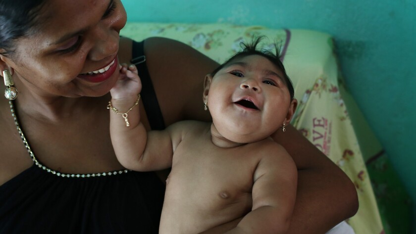 Maria da Luz Mendes Santos holds her daughter, Heloyse, who was born with microcephaly in Brazil. A new study strengthens the link between the condition and infection with the Zika virus.