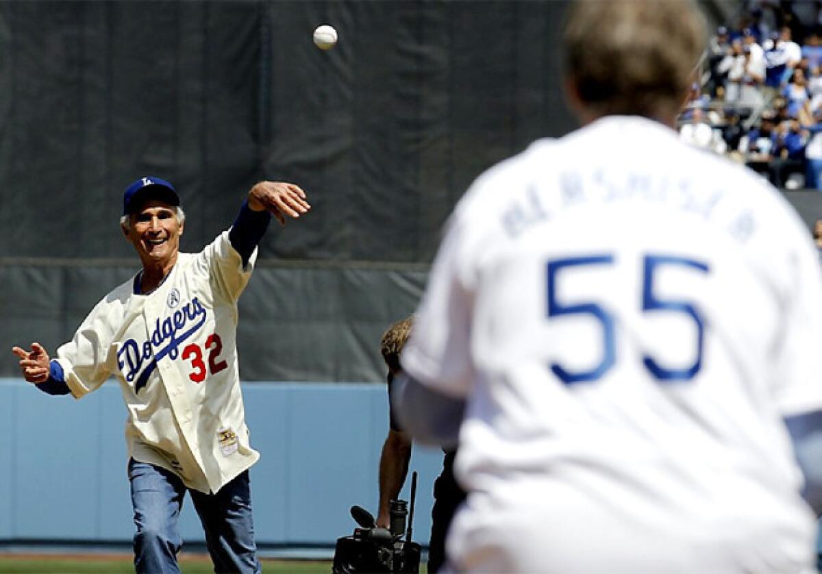 Dodgers legend Sandy Koufax throws out the first pitch on opening day against the San Francisco Giants.