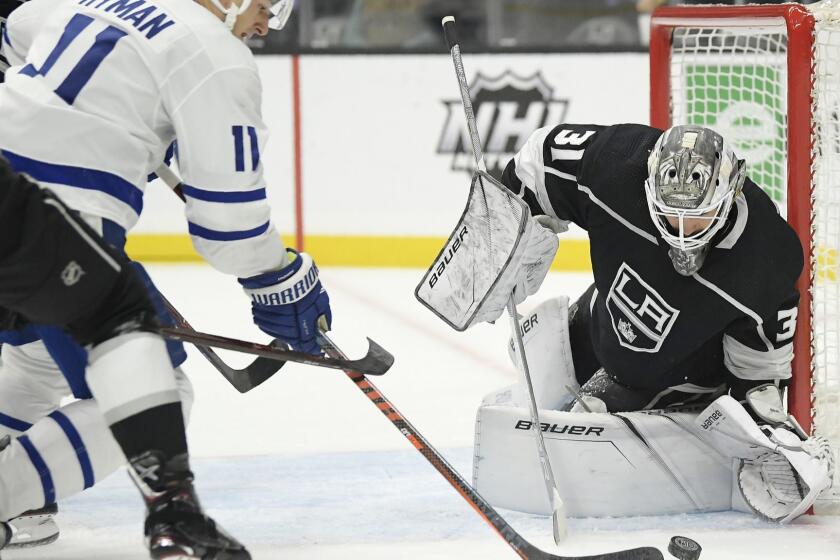 Toronto Maple Leafs left wing Zach Hyman, left, tries to get a shot past Los Angeles Kings goaltender Peter Budaj, of Slovakia, during the first period of an NHL game Tuesday, Nov. 13, 2018, in Los Angeles. (AP Photo/Mark J. Terrill)