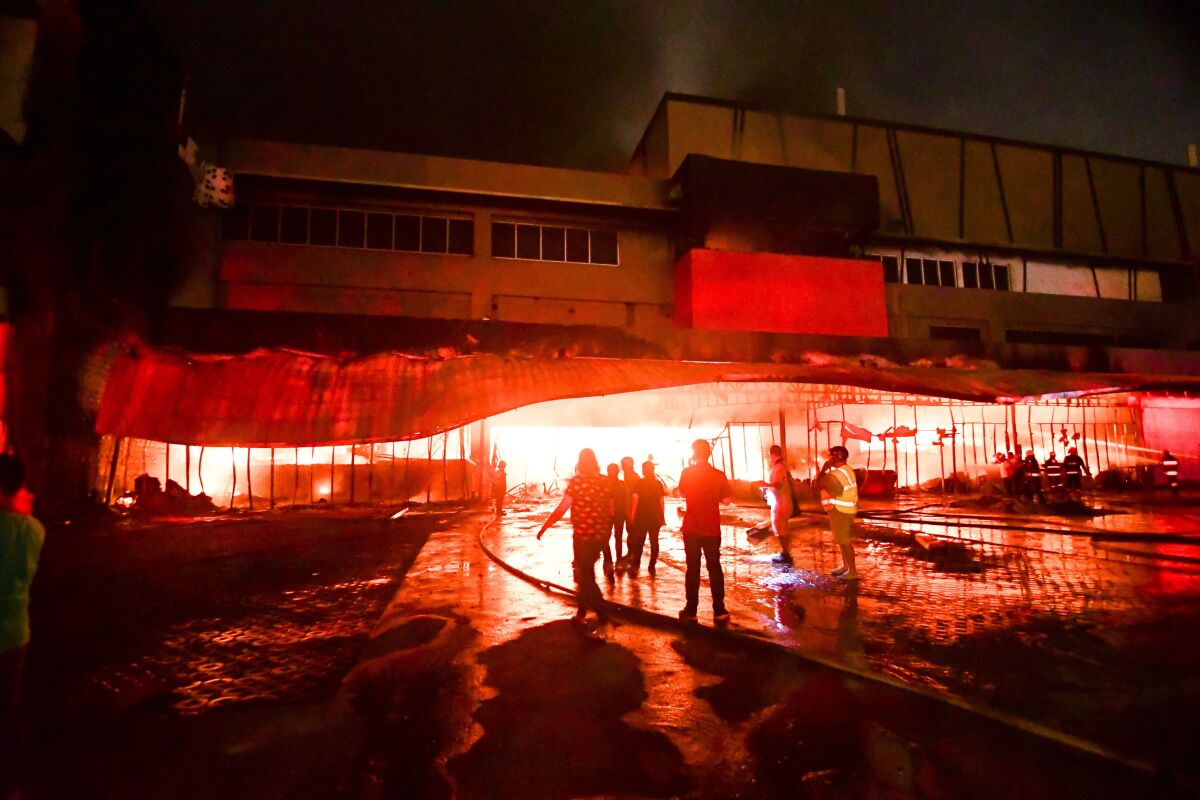Firemen try to put out a fire in a mall following a quake in General Santos City, in the southern Philippines on Wednesday.