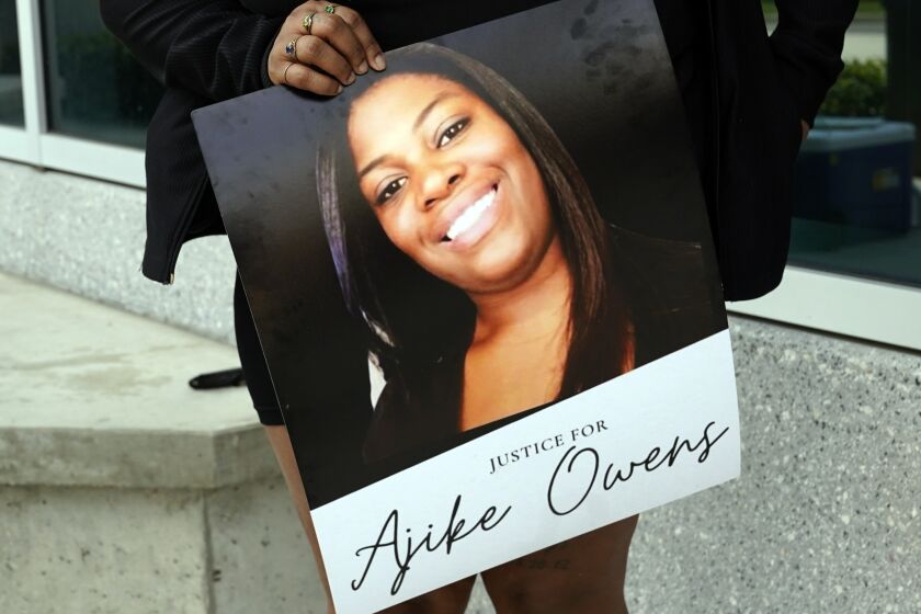 A protester, holds a poster of Ajike Owens at the Marion County Courthouse, Tuesday, June 6, 2023, in Ocala, demanding the arrest of a woman who shot and killed Owens, a 35-year-old mother of four, last Friday night, June 2. Authorities came under intense pressure Tuesday to bring charges against a white woman who killed Owens, a Black neighbor, on her front doorstep, as they navigated Florida’s divisive stand your ground law that provides considerable leeway to the suspect in making a claim of self defense. (AP Photo/John Raoux)