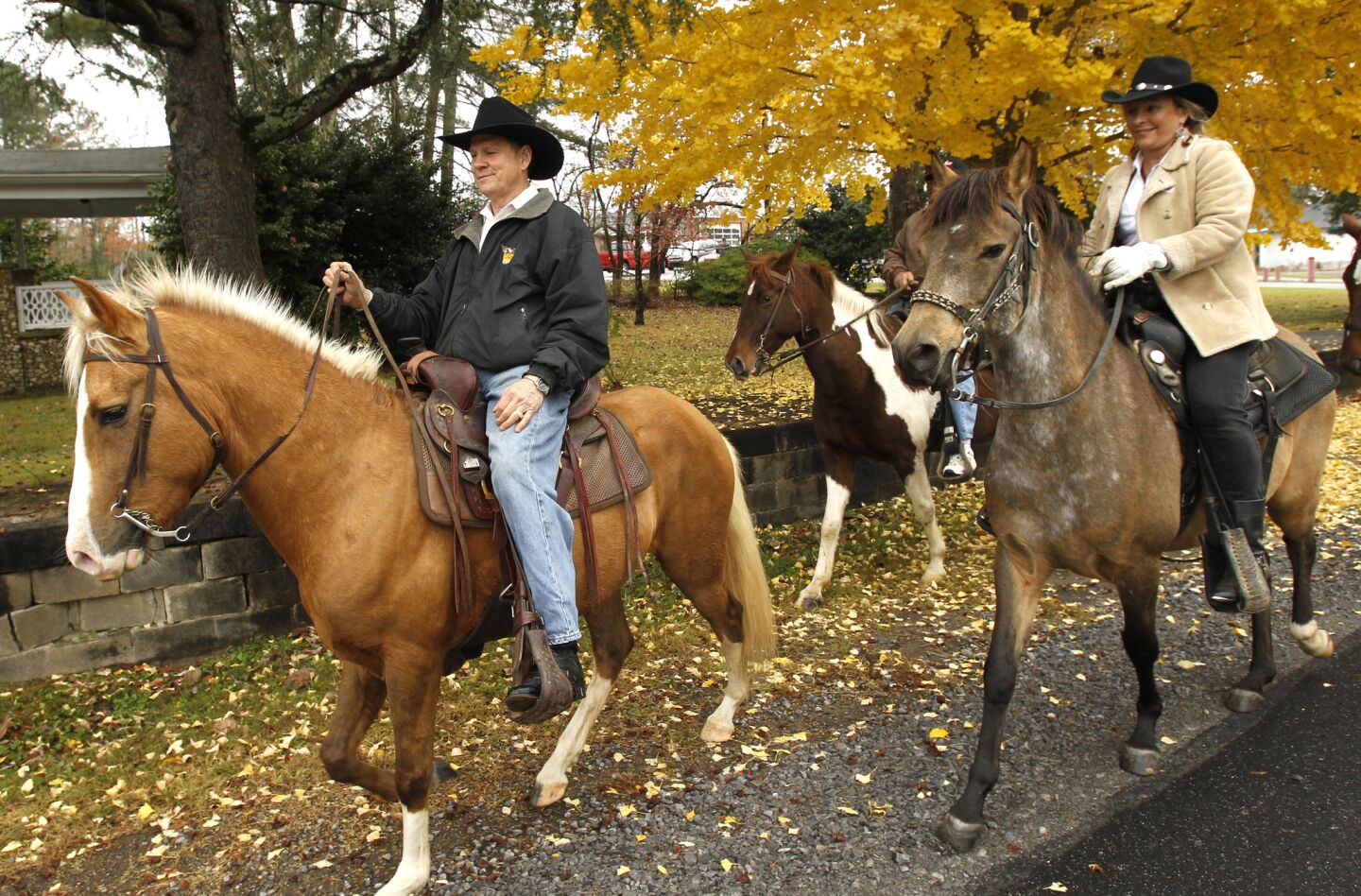 Judge Roy Moore rides his horse with wife Kayla and friends back home after they voted in Gallant, Ala. Moore is running for reelection to be chief justice of the Alabama Supreme Court.