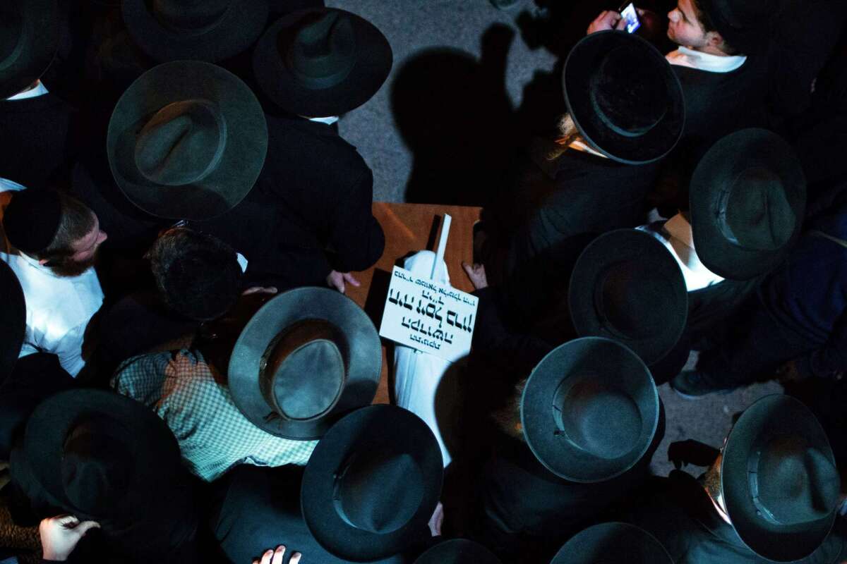 Ultra-Orthodox Jewish mourners carry the body of 3-month-old Chaya Zissel Braun during her funeral in Jerusalem on Thursday.