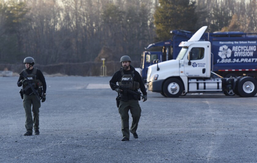 Winston-Salem Police officers in tactical gear patrol outside the Joycelyn V. Johnson Municipal Services Center after reports of gunshots in Winston-Salem, N.C. early Friday, Dec. 20, 2019. Winston- Salem Police are confirming there was a shooting but are not saying at this time if there are any injuries or deaths. (Walt Unks/Winston-Salem Journal via AP)