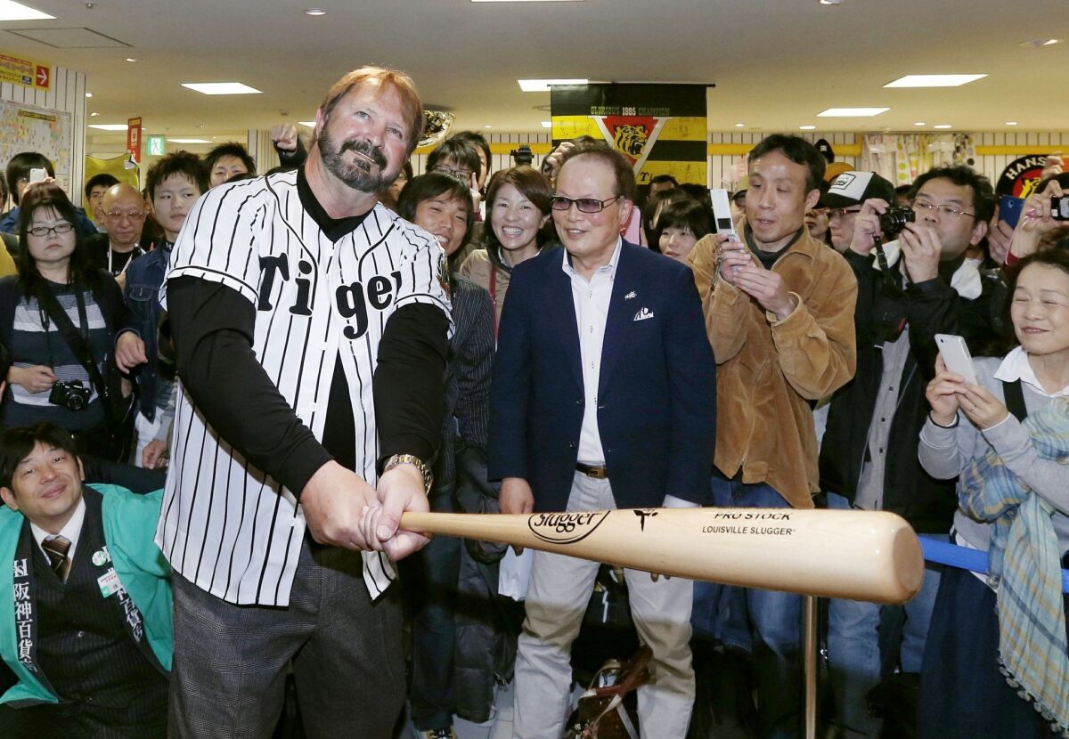 State Sen. Randy Bass, wearing Hanshin Tigers' uniform, poses with a bat in 2015.