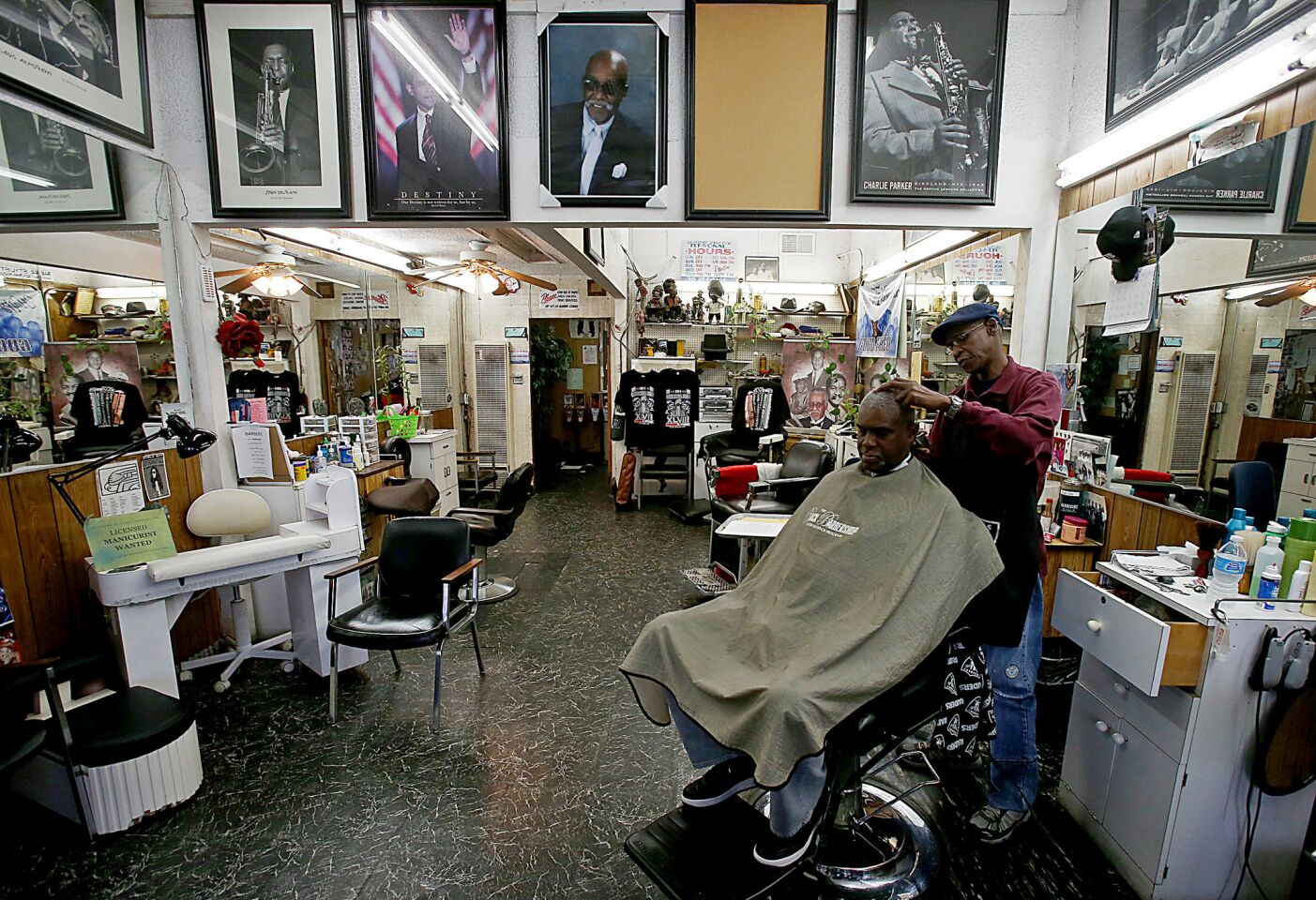 Joe Randle gets a haircut from Leon Williams at Goof Fred Barber Shop. Although crime is down significantly across South Los Angeles, violence remains stubbornly common in pockets of Chesterfield Square and beyond.