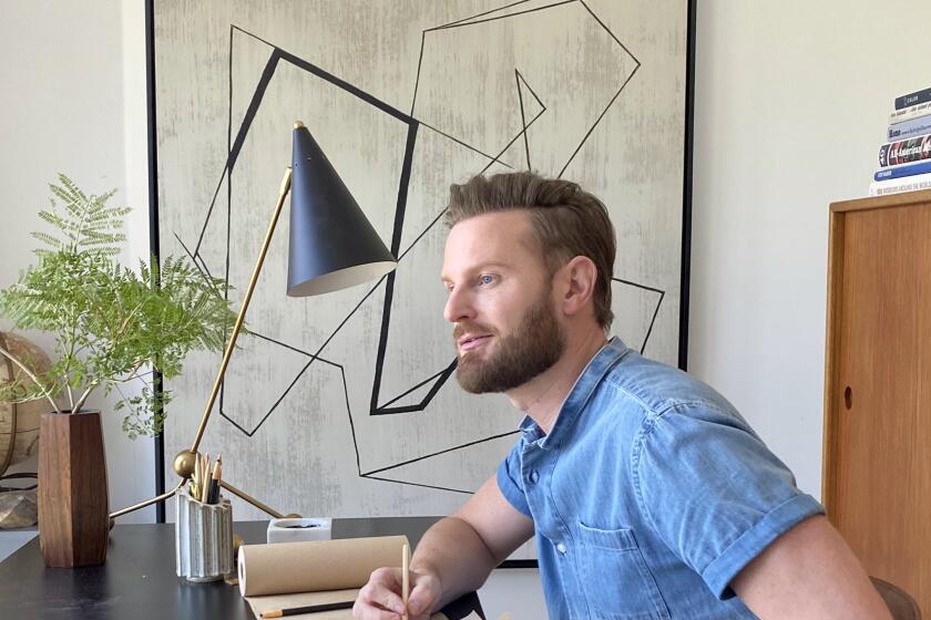 "Queer Eye" design expert Bobby Berk, pictured in his home office, is bringing his professional eye to the Emmy winners' home decor.