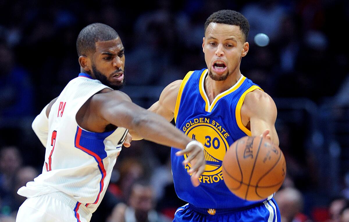 Clippers' Chris Paul steals the ball from the Warriors' Stephen Curry during the first quarter Thursday.