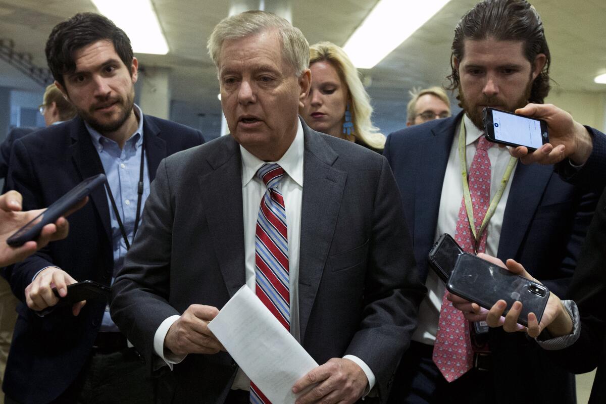Sen. Lindsey Graham (R-S.C.) speaks to reporters as he walks to the Senate chamber for the impeachment trial