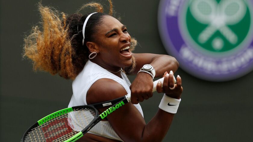 Serena Williams hits a return during a match at Wimbledon.