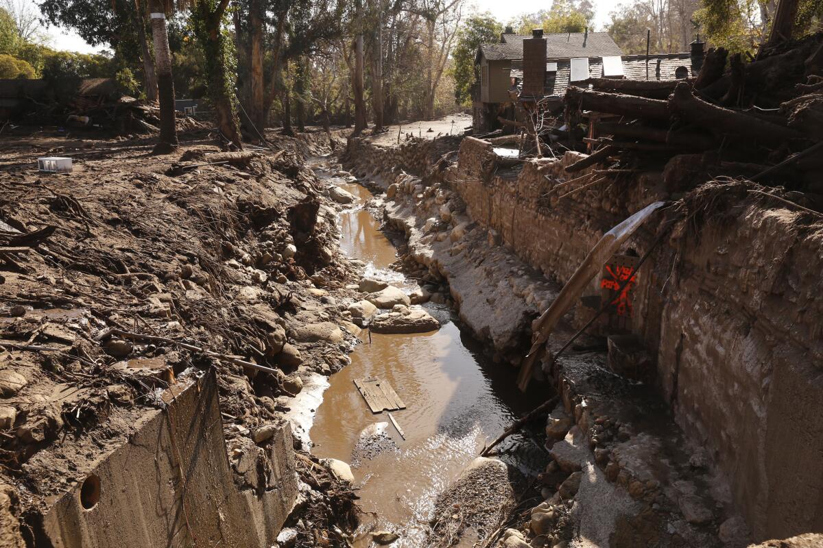 Water rises high near a home on East Valley Road on Friday in Montecito.