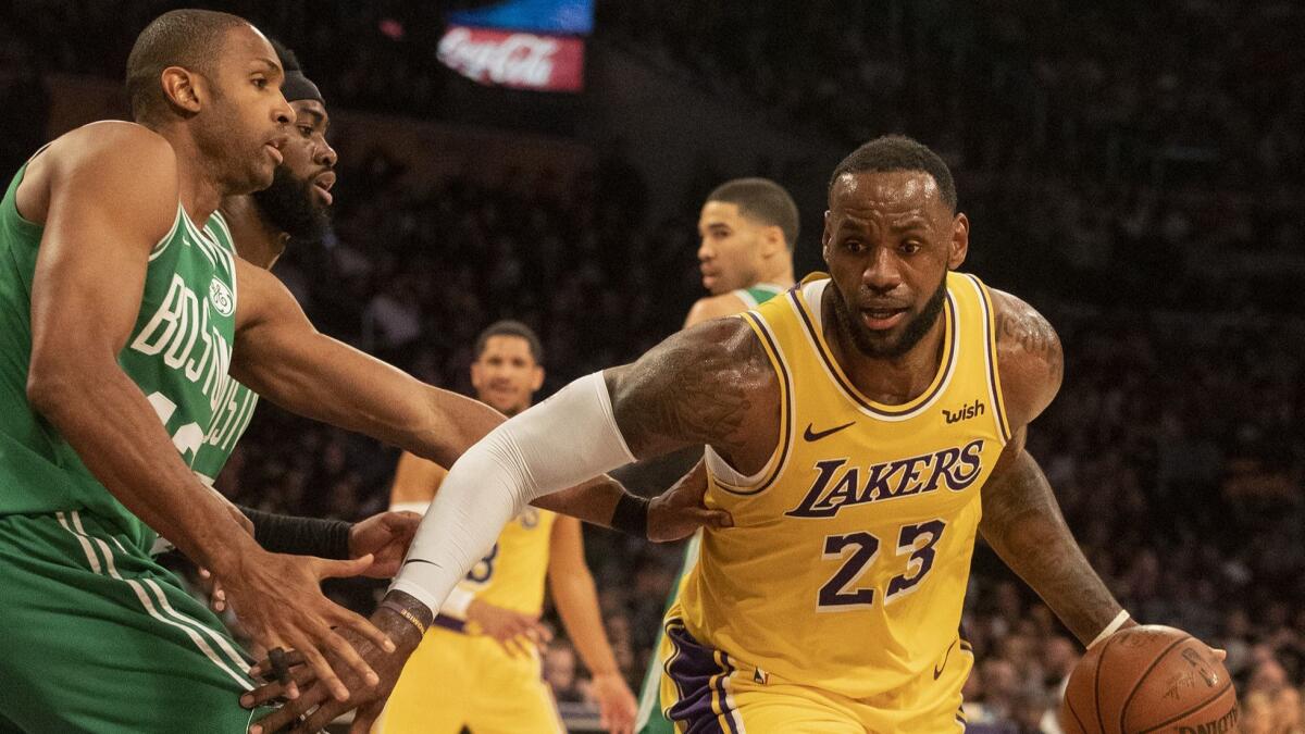 LeBron James drives to the basket as the Celtics' Al Horford defends in the fourth quarter at Staples Center.