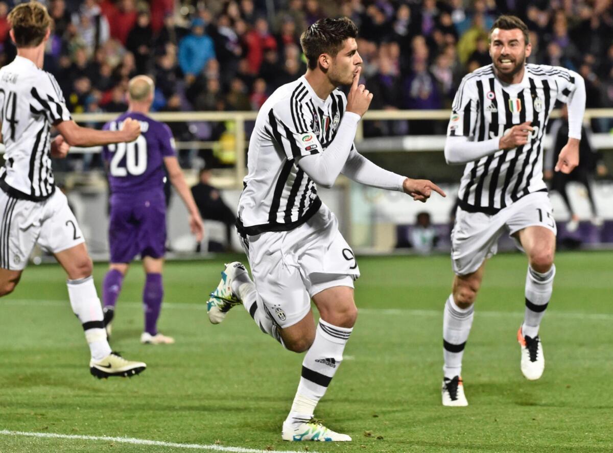 Juventus' forward Alvaro Morata, center, celebrates after he scored during a Serie A soccer match at the Artemio Franchi stadium in Florence, Italy Sunday , April 24, 2016. (Maurizio Degl'Innocenti/ANSA via AP) ITALY OUT