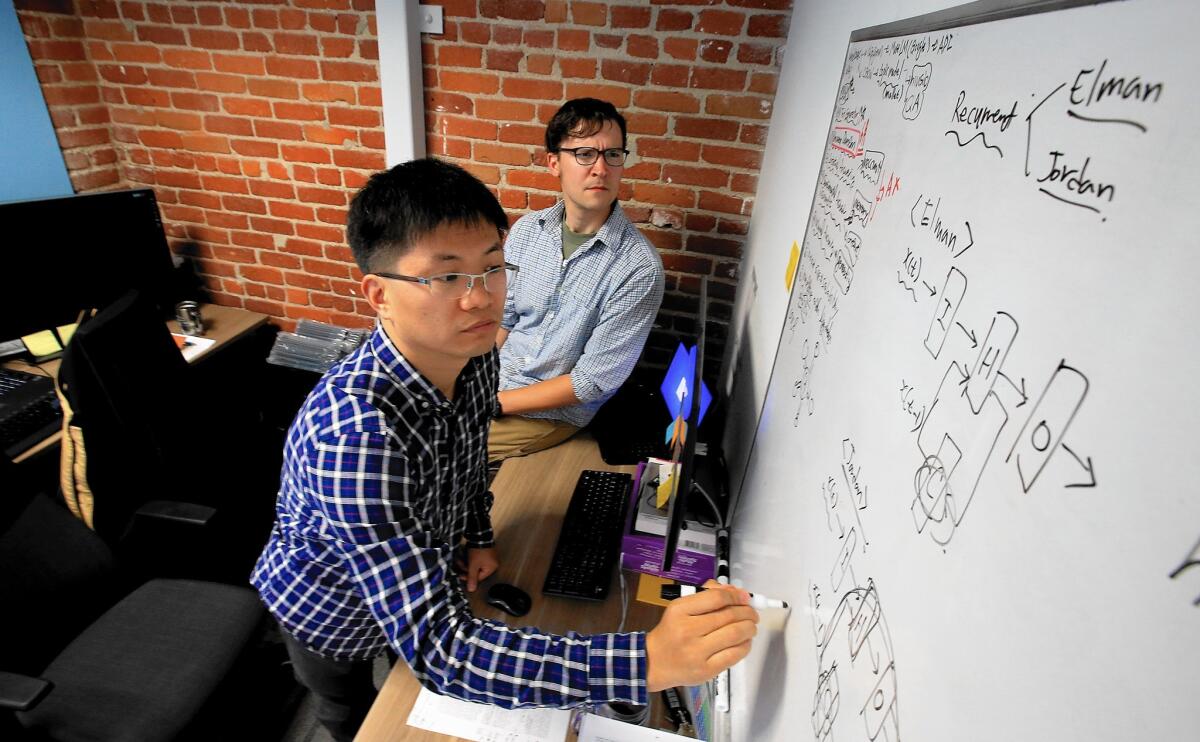 David Kim, left, and Jacob Bradsher work at AKAStudy’s Santa Monica office. The company set up shop in the U.S. partly to improve its ability to recruit to be a more attractive employer to South Korean engineers who wanted to educate their children in the U.S.