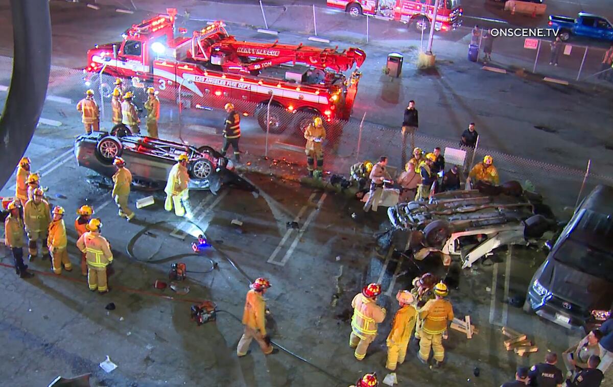 Firefighters and others at a crash scene at night. 
