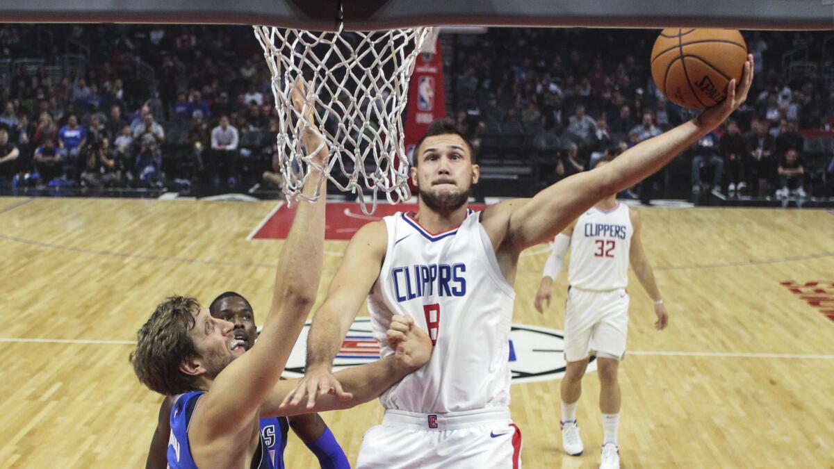 Clippers forward Danilo Gallinari drives to the basket against Mavericks forward Dirk Nowitzki during their game Wednesday night.