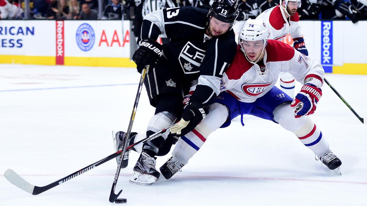 Kings left wing Kyle Clifford tries to fend off a challenge by Canadiens defenseman Alexei Emelin during the second period Thursday.