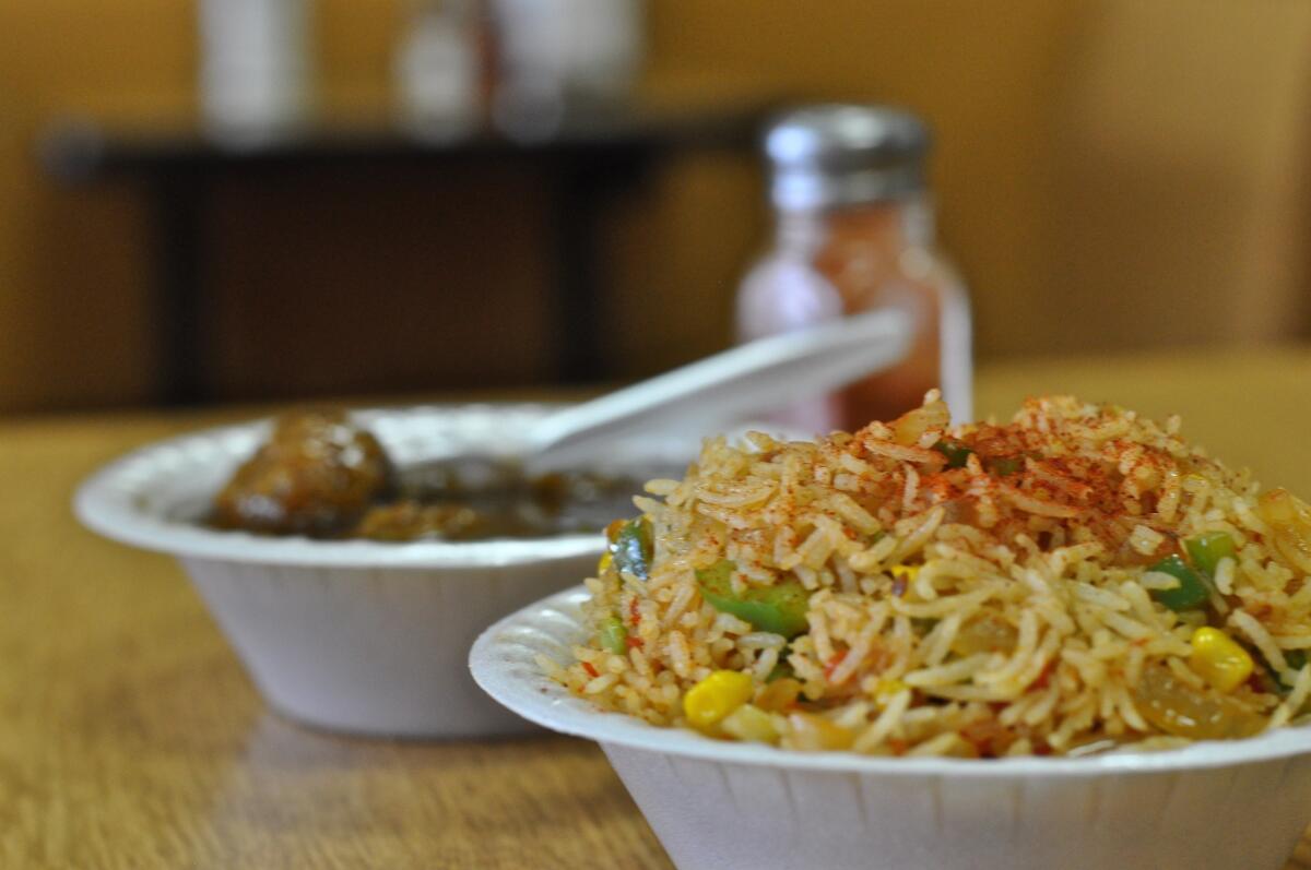 The 34-year-old Indian shop now has three new Indo-Chinese dishes on the menu: fried rice, chili paneer and Manchurian. Shown here are the fried rice and the Manchurian -- which isn't made with chicken, but is vegetarian.