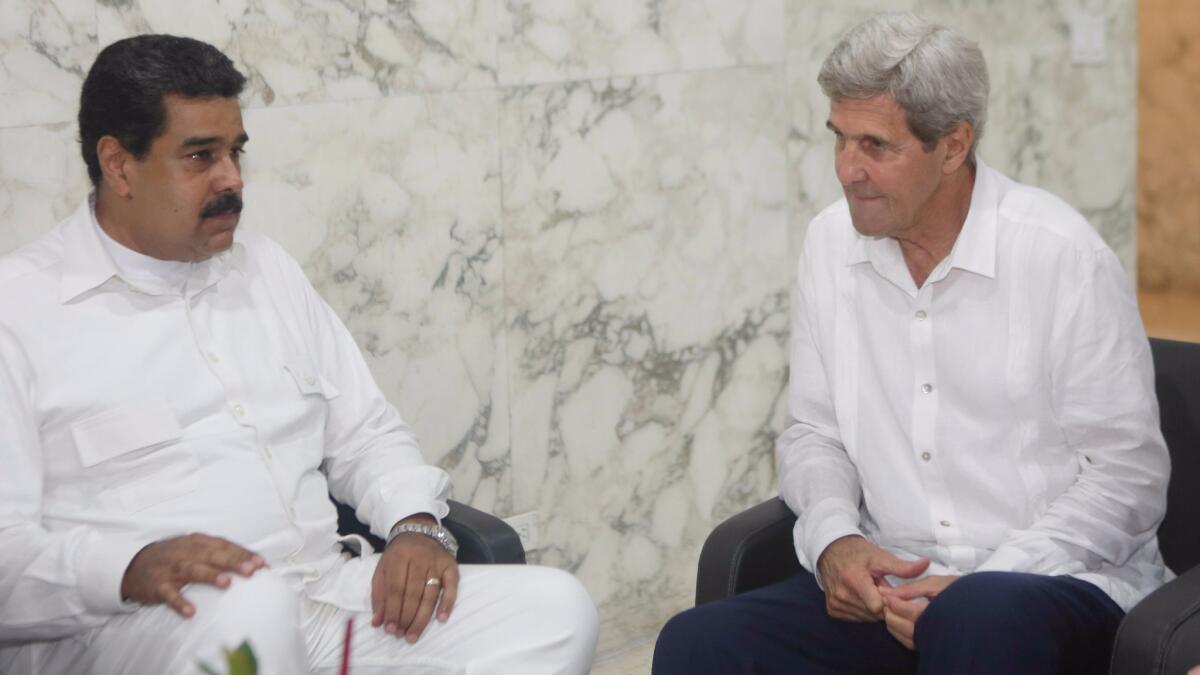 Picture released by the Venezuelan presidency showing Venezuelan President Nicolas Maduro (left) talking with U.S. Secretary of State John Kerry (right) before the peace agreement signing ceremony in Cartegena.