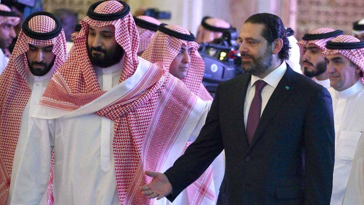 Saudi Crown Prince Mohammed bin Salman arrives with former Lebanese Prime Minister Saad Hariri at the Future Investment Initiative conference in Riyadh on Oct. 24.
