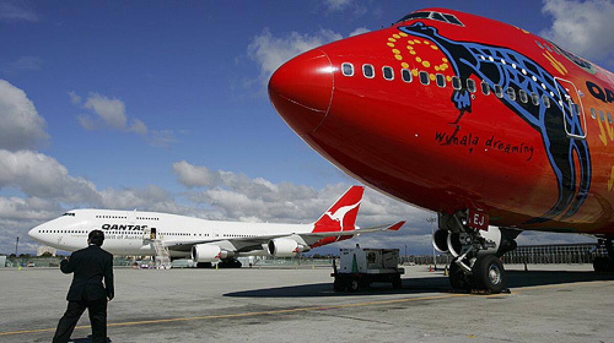 Qantas Airways airplanes are cleaned up while taxed near its hangar at LAX in this February 2007 photo. After a decade of wrangling, Australian and U.S. negotiators agreed to a landmark aviation pact to open their skies to each other's airlines, and LAX may be the big winner.