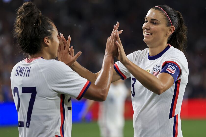 United States forward Alex Morgan, right, high-fives Sophia Smith after scoring a goal.