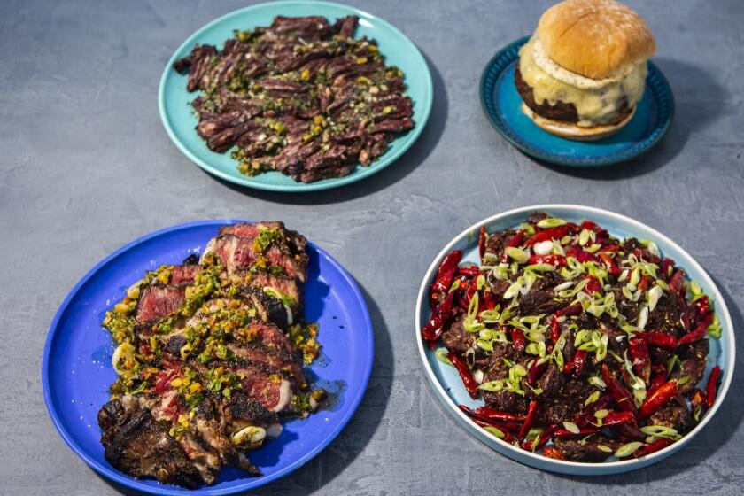 LOS ANGELES, CA--JUNE 13, 2019--Best beef dishes to make for fourth of July, clockwise from bottom right: Prime hangar steak with Szechuan spices and citrus, from chef Brandon Kida, at Hinoki & the Bird, in Century City, Aged ribeye steak with pistachio gremolata, from Vartan Abgaryan at Yours Truly in Venice, skirt steak with marjoram and lime salsa, from writer Ben Mims and dry-aged burger with gruyere and homemade mayonnaise, adapted from Katie Flannery, at Flannery Beef, photographed on a Los Angeles, CA, rooftop, June 13, 2019. (Jay L. Clendenin / Los Angeles Times)