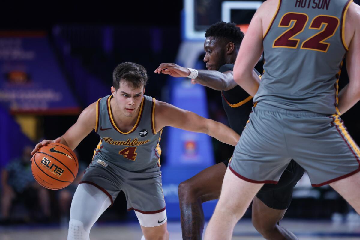 In a photo provided by Bahamas Visual Services, Loyola Chicago guard Braden Norris (4) drives on Arizona State's Jay Heath during an NCAA college basketball game at Paradise Island, Bahamas, Friday, Nov. 26, 2021. (Tim Aylen/Bahamas Visual Services via AP)