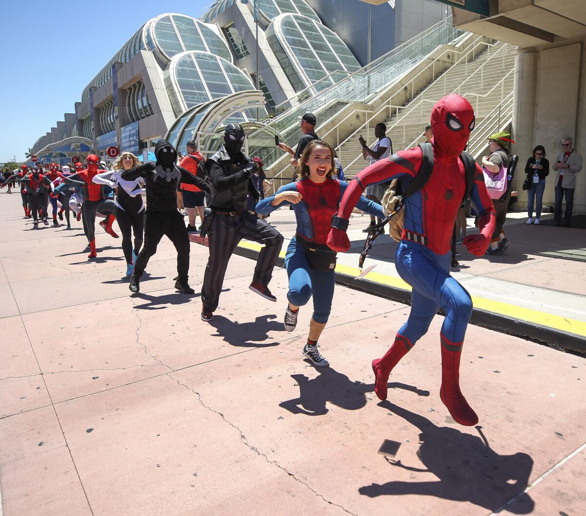 People dressed as Spider-Man dance in front of the San Diego Convention Center during Comic-Con in 2019.