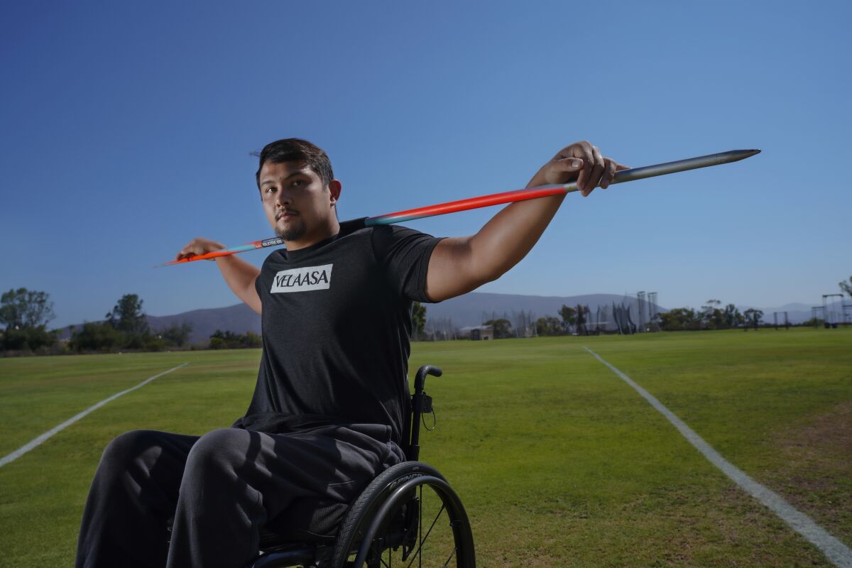 U.S. Paralympian Justin Phongsavanh, 24, poses with his javelin before a workout in Chula Vista.