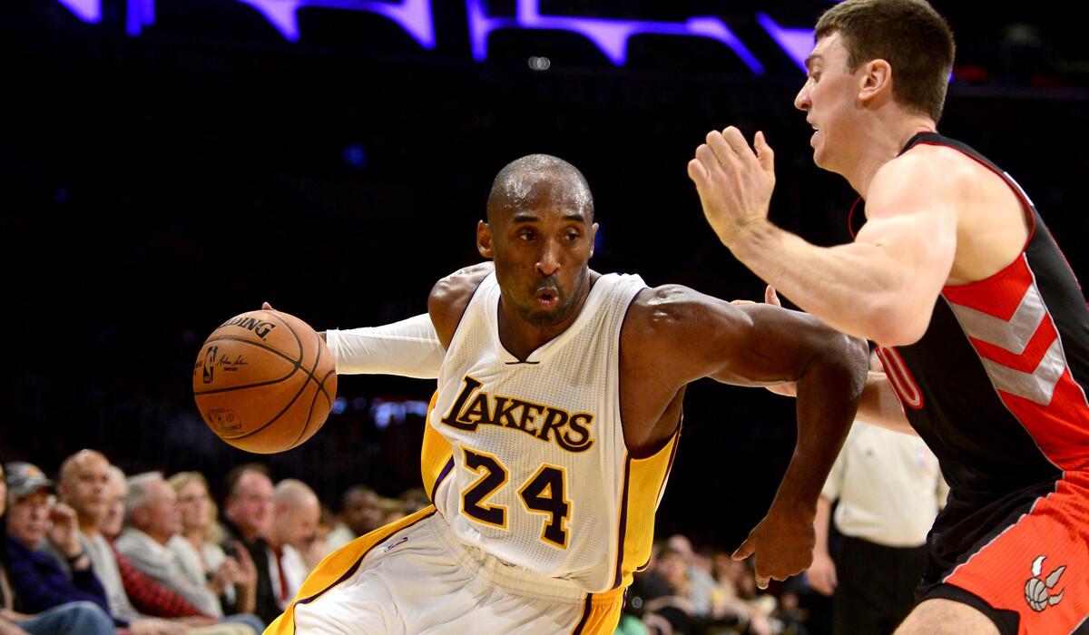 Lakers guard Kobe Bryant, who finished with 31 points, 12 assists and 10 rebounds, tries to drive around Raptors forward Tyler Hansbrough in the second half.