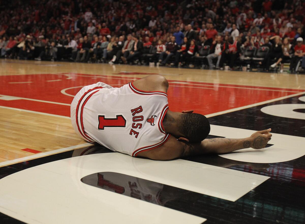 Derrick Rose lays on the floor after suffering an injury against the 76ers in Game 1 of the Eastern conference quarterfinals. (Getty Images)
