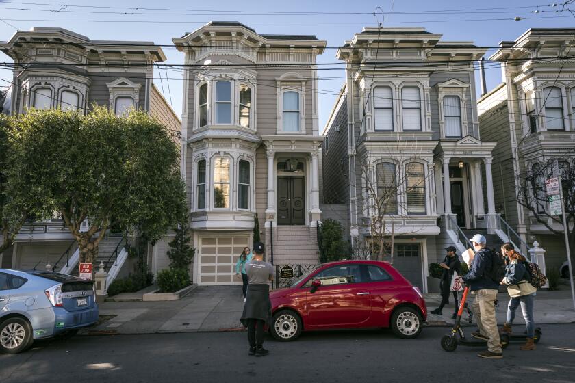 SAN FRANCISCO, CA - JANUARY 10: Fans gather to take photos at 1709 Broderick Street, the house depicted in the filming of the TV show, "Full House," after the sudden death of comedian Bob Saget in San Francisco, Calif., on Monday, January 10, 2022. Saget was found dead in his hotel room Sunday at the Ritz-Carlton Orlando, Grande Lakes in Florida. (Carlos Avila Gonzalez/San Francisco Chronicle via Getty Images)