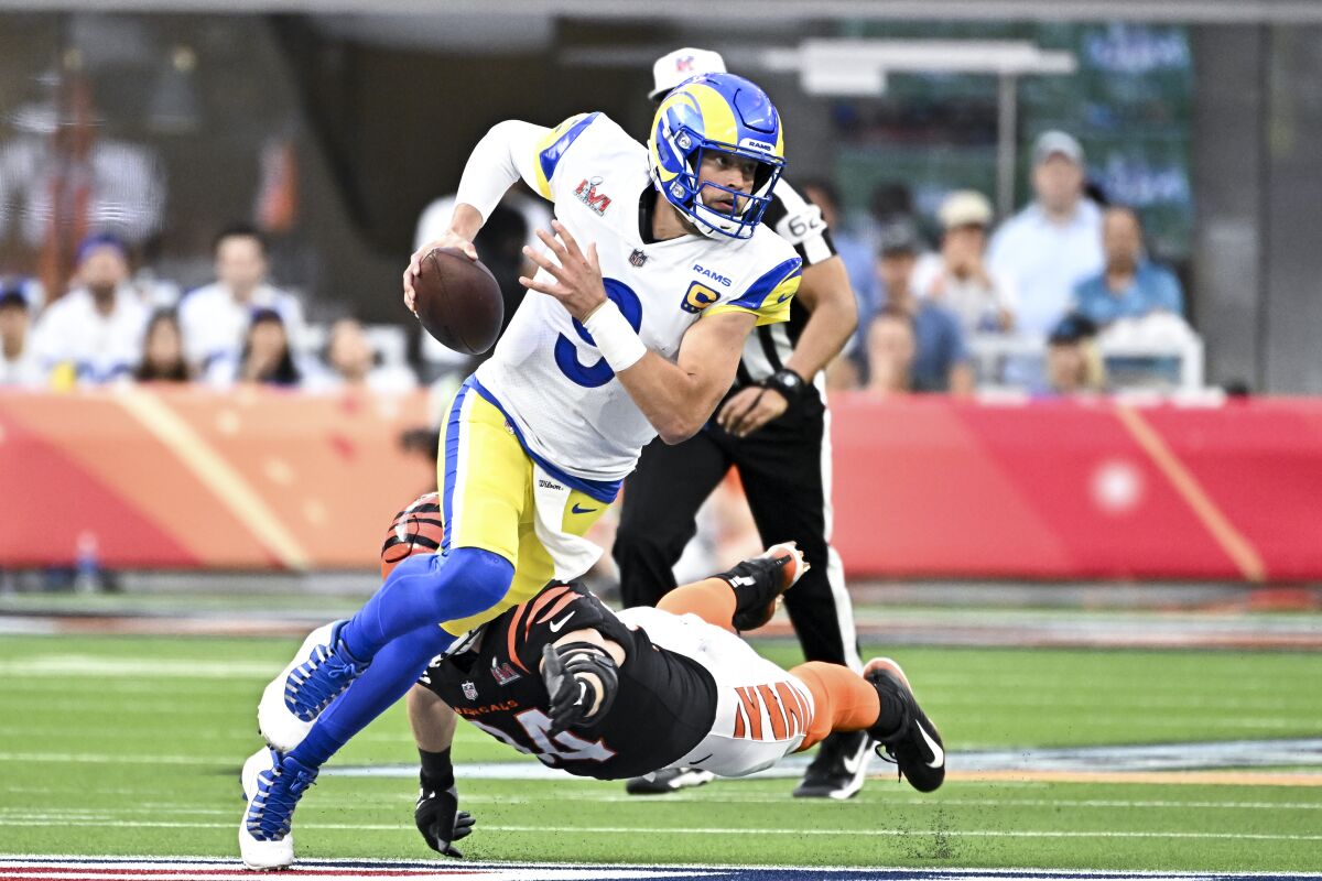 Rams quarterback Matthew Stafford avoids a tackle in first quarter.